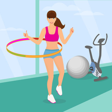 Beautiful woman exercising with hula hoop in the gym