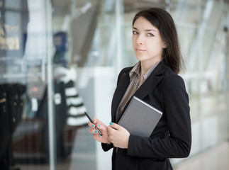 Young girl with pen and notebook.