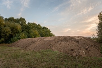 Large pile of soil under blue sky