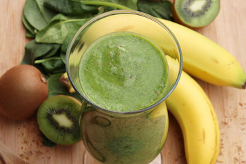 Green smoothie made with kiwi, spinach and banana - 63663373