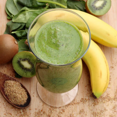 Green smoothie made with kiwi, spinach and banana - 63663374