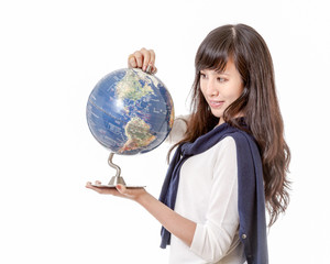 Asian woman staring at globe