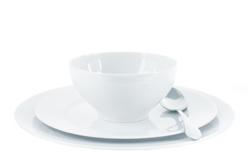 Empty plate with spoon on white background