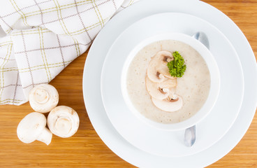 Mushroom soup and champignon on white background