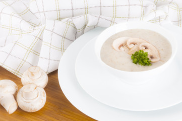 Mushroom soup and champignon on white background