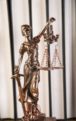 Lady of justice, wooden & gold gavel and books on wooden table - 63665569