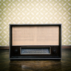 vintage radio receiver device on the weathered wooden parquet fl