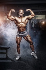Naklejka na ściany i meble Bodybuilder man posing in the gym