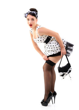 Pinup girl on high heels in spotted dress stocking, full length