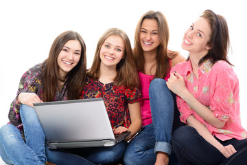 Happy teen girls learning with notebook, over white