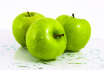Green apples with waterdrops on table