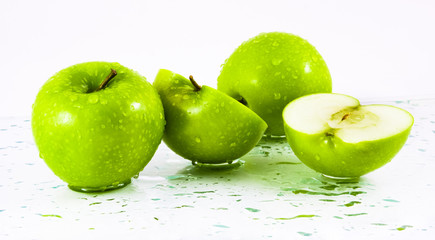 Green apples with waterdrops on table
