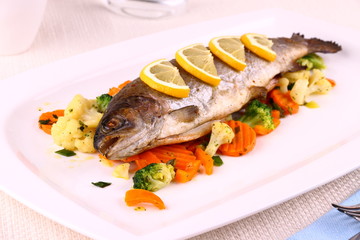 Grilled whole trout, vegetables and lemon