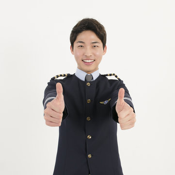 Cheerful airline pilot with thumb up