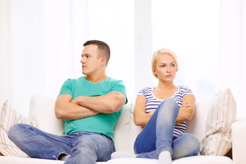 unhappy couple having argument at home