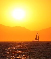 Obraz na płótnie Canvas Sunset and Sailboat