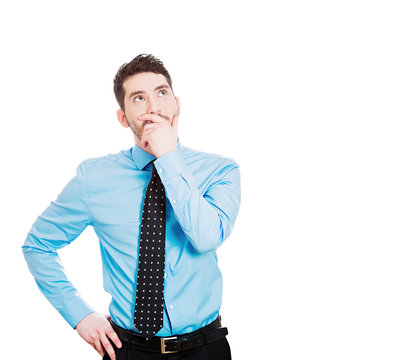 Portrait young serious business man thinking, isolated on white