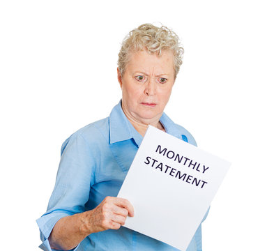 Angry older woman unhappy with her monthly statement