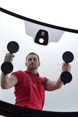 mechanic holding windshield