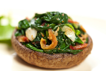 Stuffed mushroom with spinach and bacon. Selective focus. Macro.