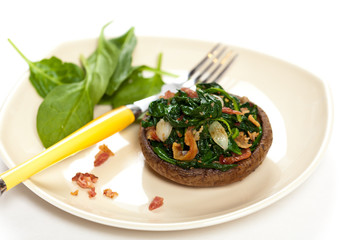 Stuffed mushroom with spinach and bacon. Selective focus. Macro.
