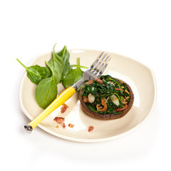 Stuffed mushroom with spinach and bacon. Selective focus. Macro.