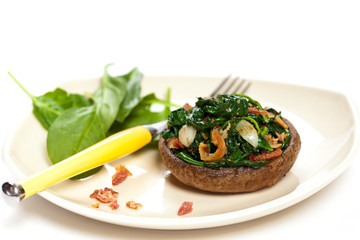 Stuffed mushroom with spinach and bacon. Selective focus. Macro.