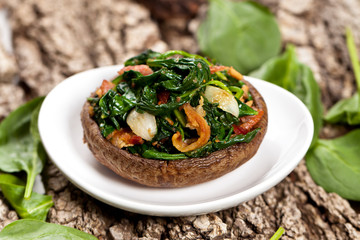Stuffed mushroom with spinach and bacon. Selective focus. Macro.