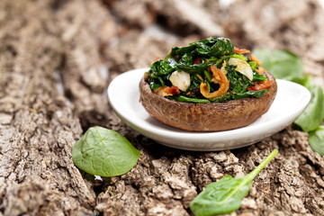 Stuffed mushroom with spinach and bacon. Selective focus. Macro.