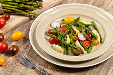 Vegetable salad with asparagus and tomato