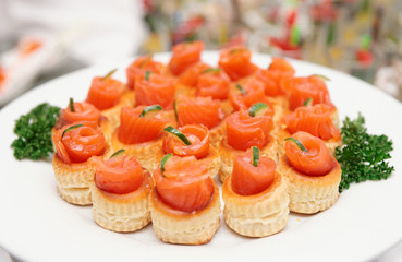 Tartlets with salmon on table