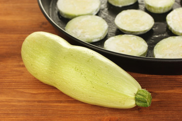 sliced squash in a pan on wooden table close-up