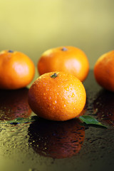 Ripe sweet tangerines, on dark color background