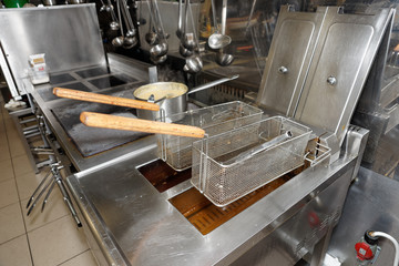 Deep fryers with oil on kitchen