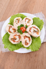 Delicious chicken roll on plate on table close-up