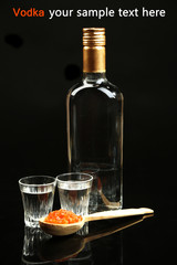 Bottle of vodka, red caviar  isolated on black