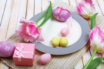 Easter table setting with tulips and eggs