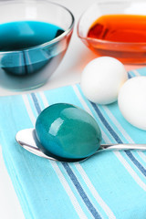 Bowls with paint for Easter eggs and eggs, close up