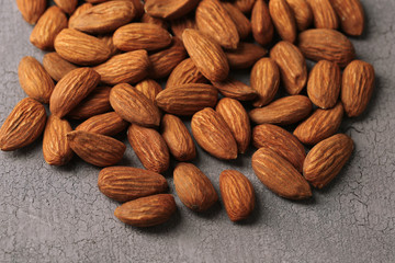 Almonds on color wooden background