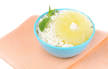 Bowl of tasty cottage cheese with pineapple, isolated on white