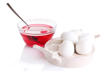 Eggs with liquid colour in glass bowl isolated on white