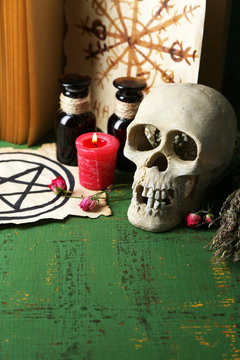 Composition with skull,old book, magic potions, candle and dry