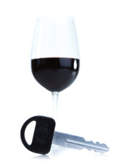 Composition with car key and glass of wine, isolated on white