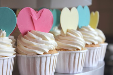 Cupcake decorated with frosting and sugar hearts.