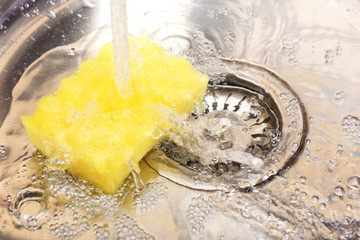Water flowing down hole in kitchen sink