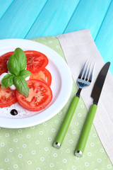 Caprese salad with mozarella cheese, tomatoes and basil