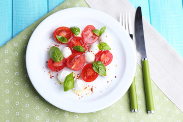 Caprese salad with mozarella cheese, tomatoes and basil