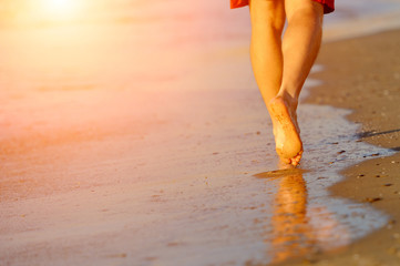 Running legs of runner on beach