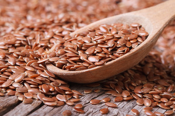 Flax seeds close up on a wooden spoon on a table. horizontal