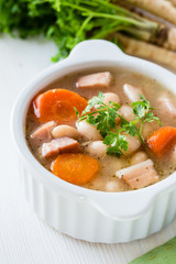 White bean soup made of  beans, carrot and ham